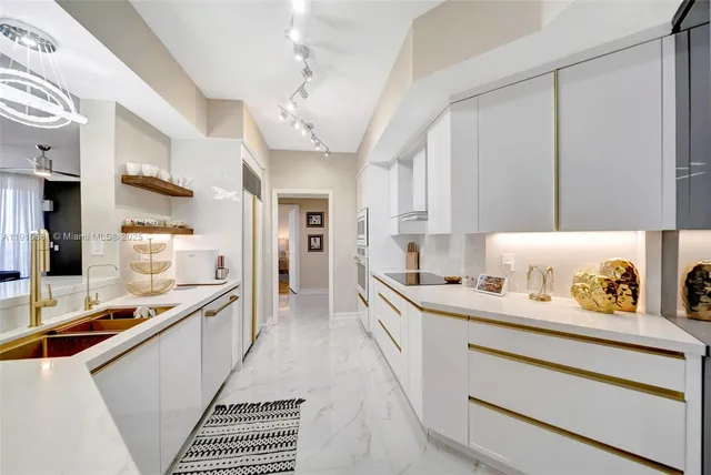 a kitchen with stainless steel appliances a sink stove and refrigerator
