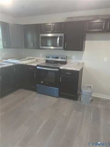 a kitchen with stainless steel appliances granite countertop a sink and a stove