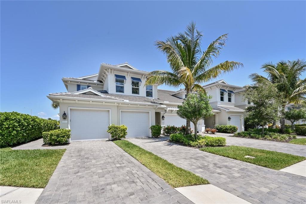 6934 Avalon Circle, Unit 401 Naples, FL 34112 - Photo 13 of 13 a front view of a house with a yard and garage