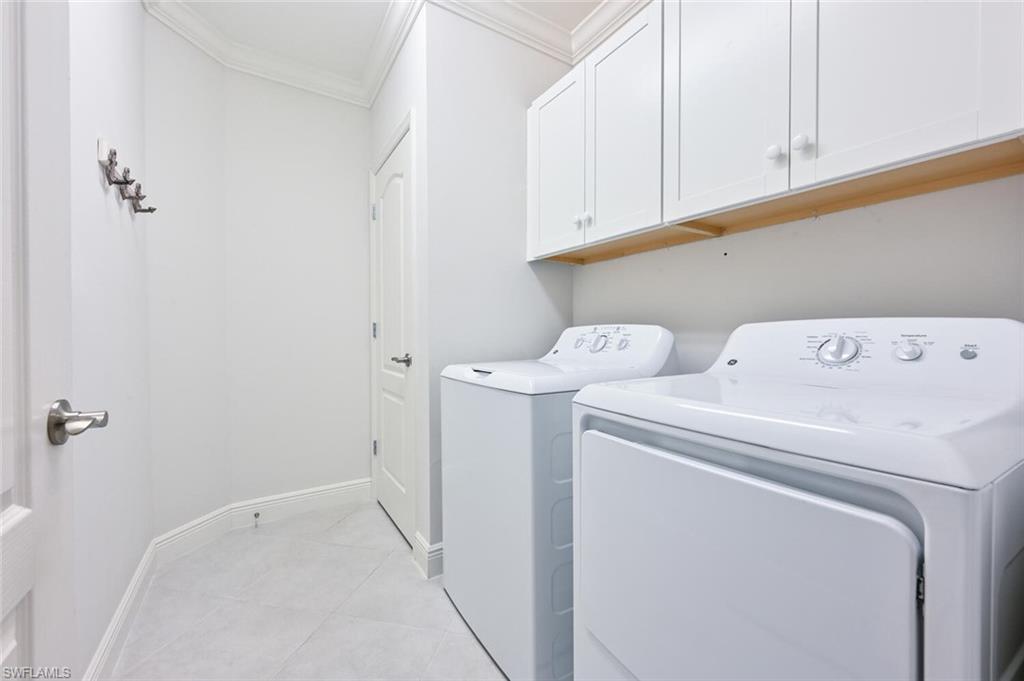 6934 Avalon Circle, Unit 401 Naples, FL 34112 - Photo 10 of 13 a utility room with dryer and washer