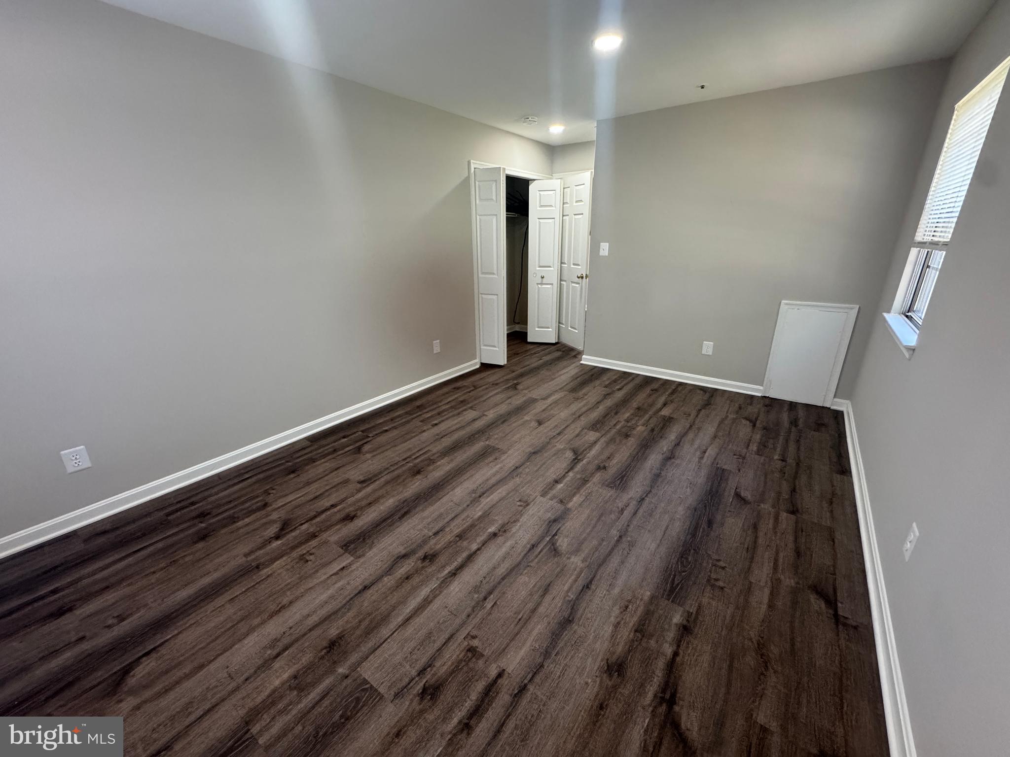 11263 Raging Brook Drive, Unit 253 Bowie, MD 20720 - Photo 5 of 22 a view of an empty room and wooden floor