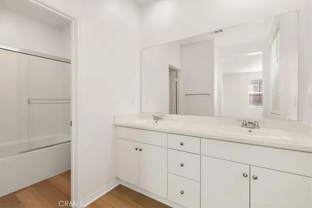 a bathroom with a double vanity sink and mirror