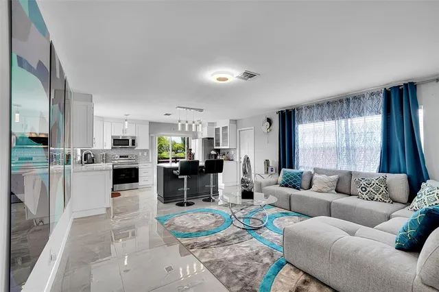 a living room with furniture and a large window