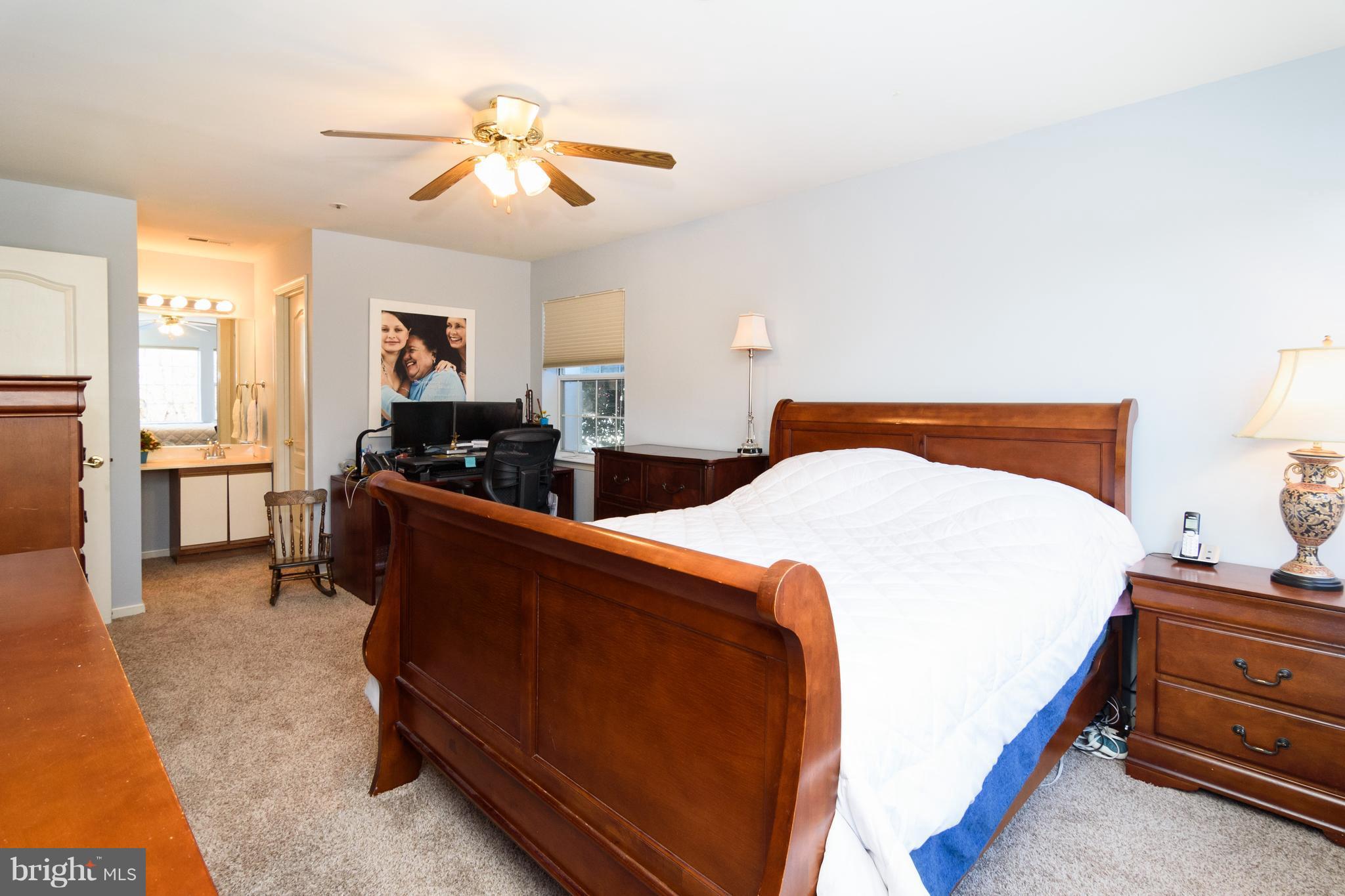 8611 Falls Run Road, Unit B Ellicott City, MD 21043 - Photo 14 of 24 Master bedroom w/walk-in closet and ceiling fan