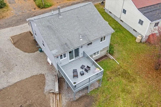 a white building with a big yard and large tree
