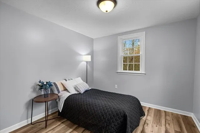 a bedroom with a bed and a lamp