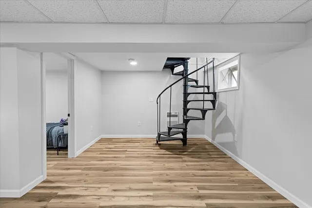 a view of a bedroom with wooden floor and closet