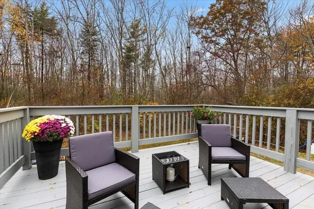 a view of a deck with wooden floor and seating space