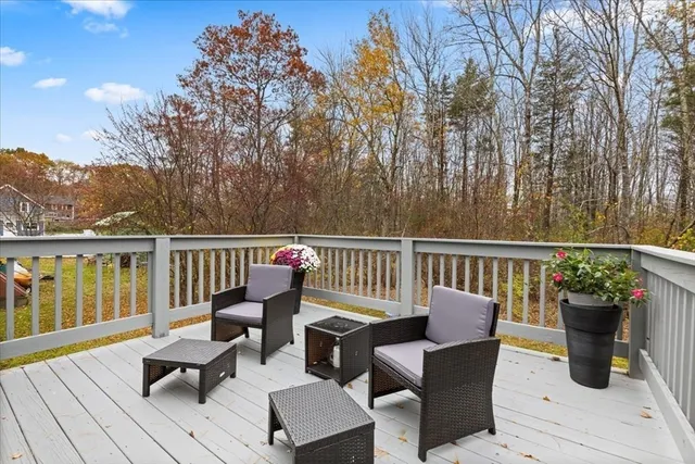 a view of a livingroom with wooden floor and a kitchen space