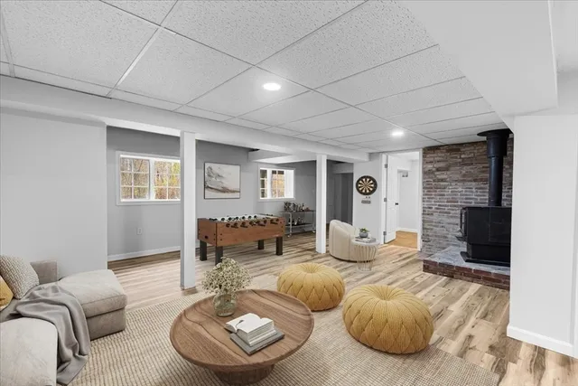 an empty room with wooden floor and fireplace