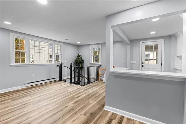 a living room with stainless steel appliances kitchen island granite countertop furniture and a window