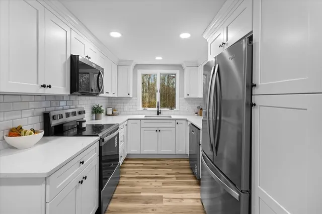 a kitchen with a refrigerator and sink
