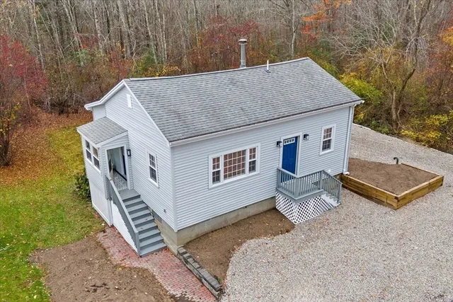 a aerial view of a house with roof deck front of house