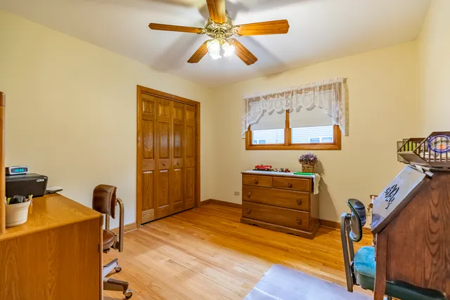 a view of a bedroom with wooden floor and stairs