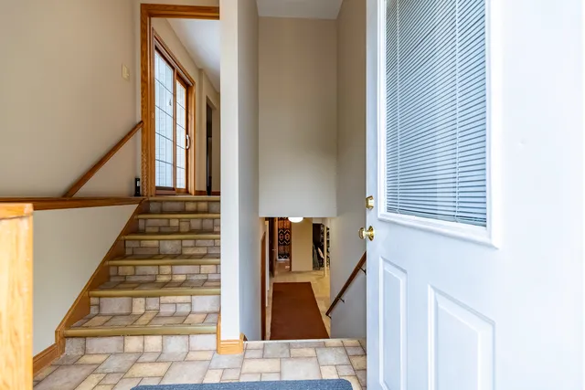 a view of a patio with table and chairs and wooden floor