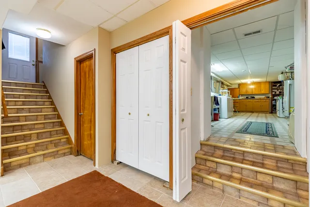 a view of balcony with wooden floor outdoor seating and barbeque oven