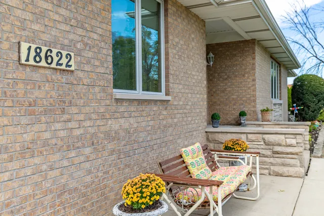 a view of a chairs and table in the balcony