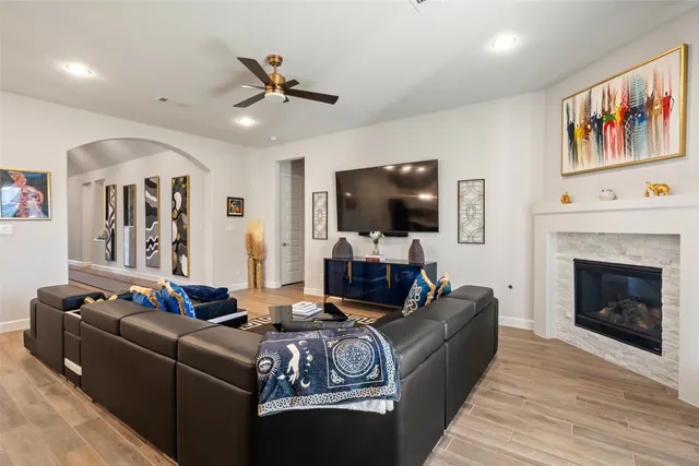 a living room with furniture a flat screen tv and a fireplace