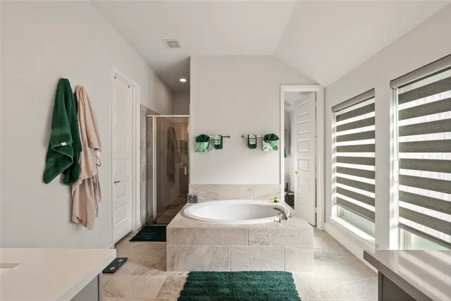 a bathroom with a tub and a shower