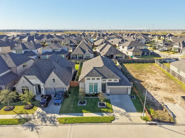 an aerial view of a house with a yard