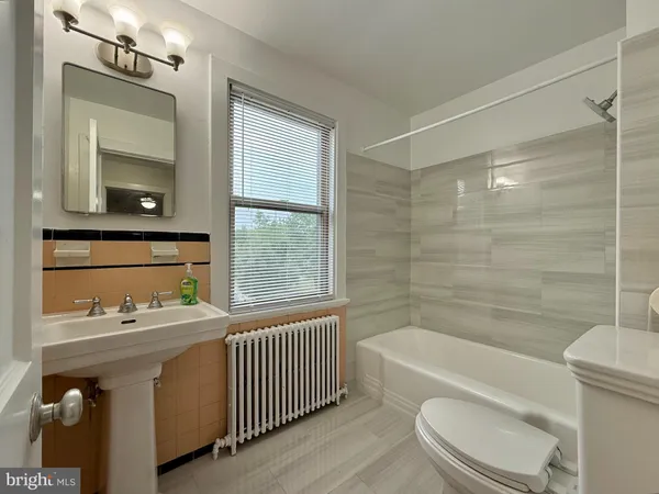a bathroom with a sink a toilet and bathtub