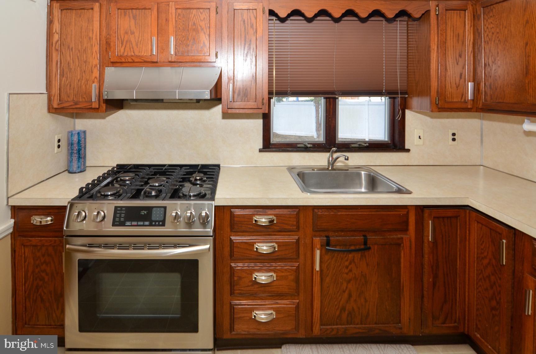 108 Winding Way Hamilton, NJ 08620 - Photo 13 of 29 a kitchen with stainless steel appliances granite countertop a stove a sink and a microwave