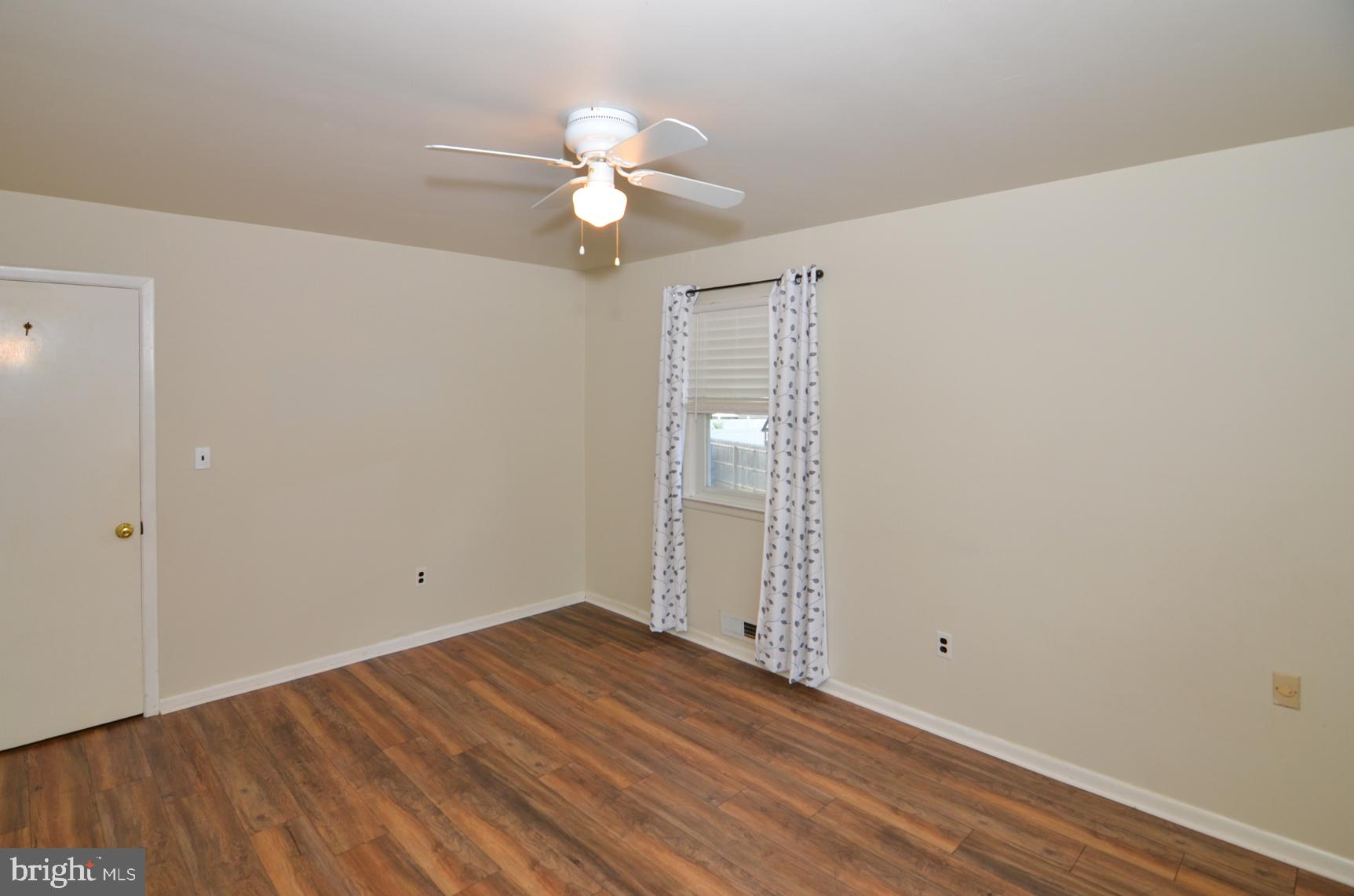 108 Winding Way Hamilton, NJ 08620 - Photo 18 of 29 an empty room with wooden floor and fan
