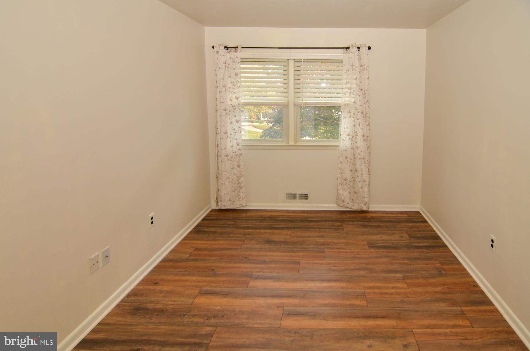 108 Winding Way Hamilton, NJ 08620 - Photo 21 of 29 a view of an empty room with wooden floor and a window