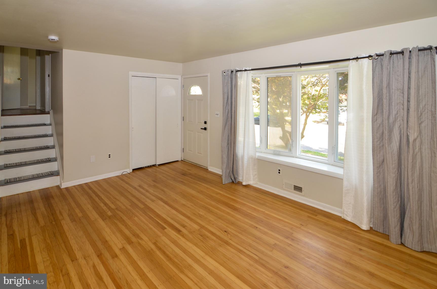 108 Winding Way Hamilton, NJ 08620 - Photo 6 of 29 a view of an empty room with wooden floor and a window