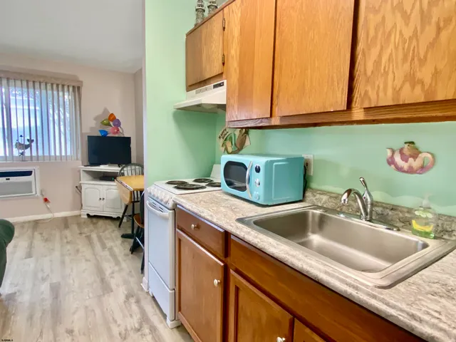 a kitchen with a sink cabinets and utility