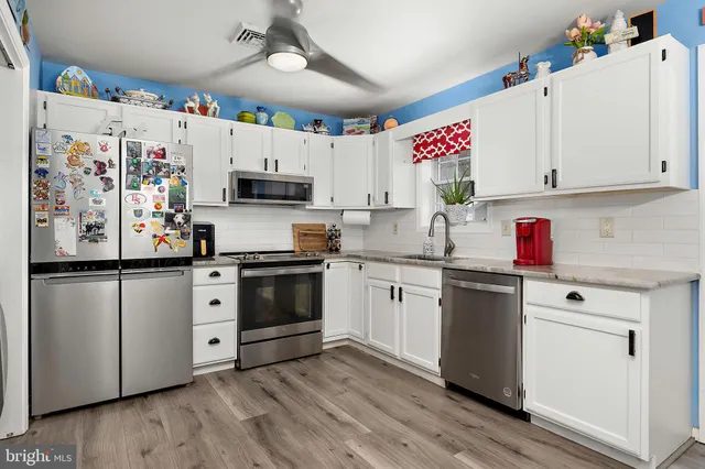 a kitchen with cabinets a sink and appliances
