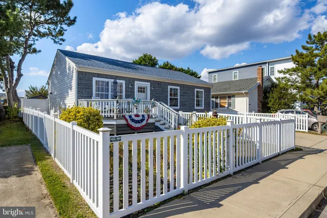 a view of a house with wooden fence