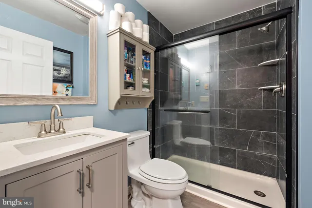 a living room with furniture flat screen tv and wall paintings