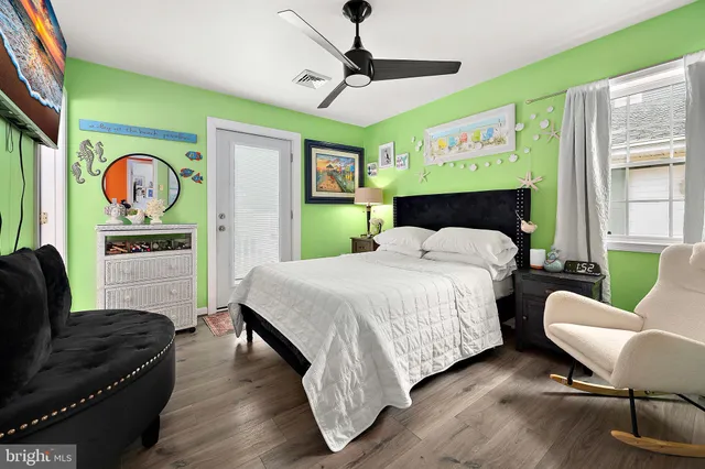 a bedroom with a bed dresser and a window