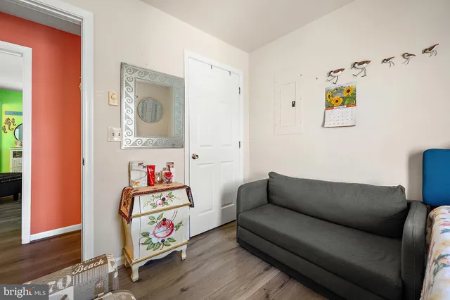a bedroom with a bed dresser and a chandelier