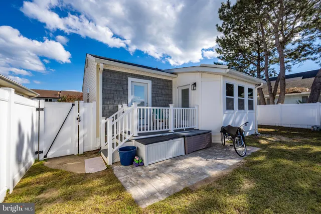 a backyard of a house with barbeque oven and table and chairs