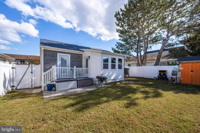 a view of a house with a swimming pool and a yard