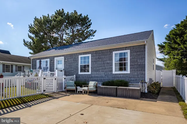 a view of a house with wooden deck