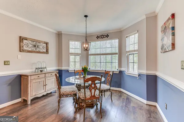 a view of a dining room with furniture window and wooden floor