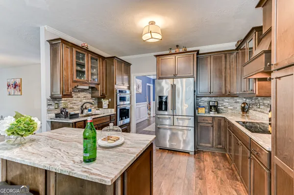 a kitchen with granite countertop stainless steel appliances and wooden cabinets
