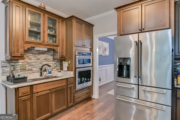 a kitchen with stainless steel appliances granite countertop a refrigerator and a sink