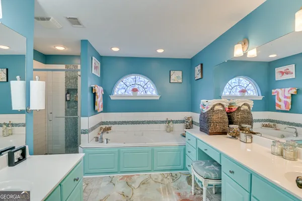 a bathroom with a sink mirror and a bath tub