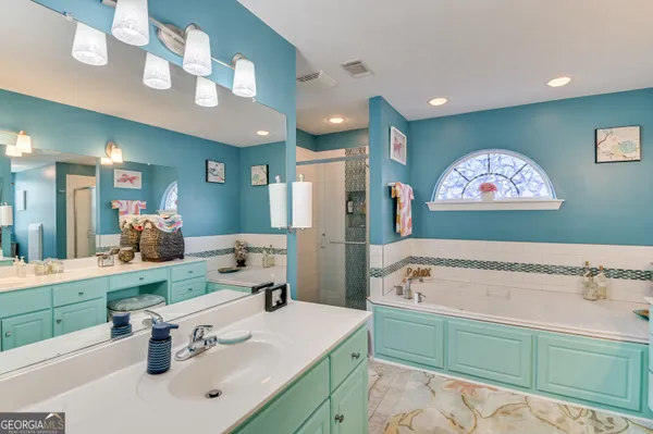 a bathroom with a sink a mirror and a shower