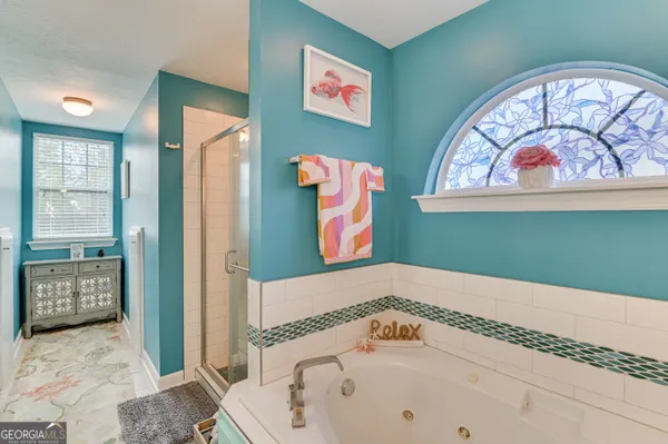a bathroom with a bathtub and a shower
