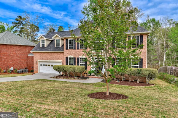 a front view of a house with a yard