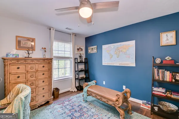 a bedroom with furniture and a book shelf