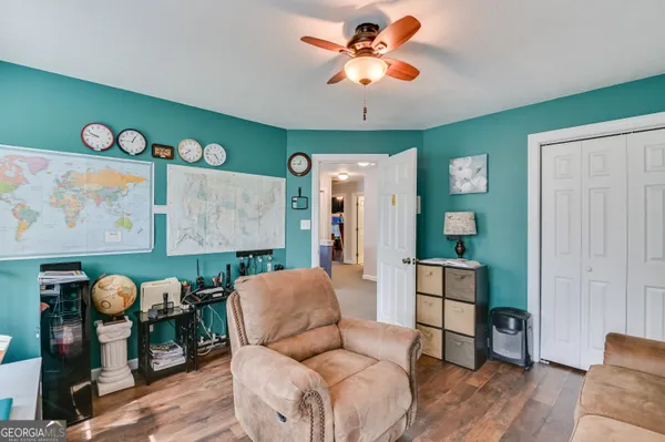 a living room with furniture and wooden floor