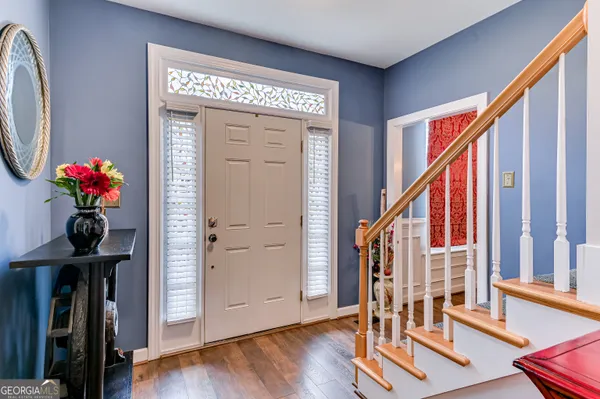 a view of an entryway with wooden floor