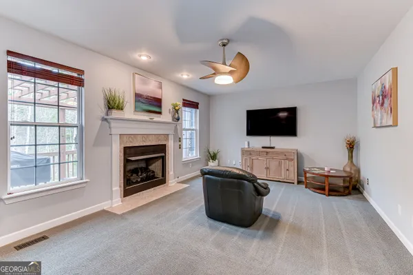 a living room with furniture fireplace and flat screen tv