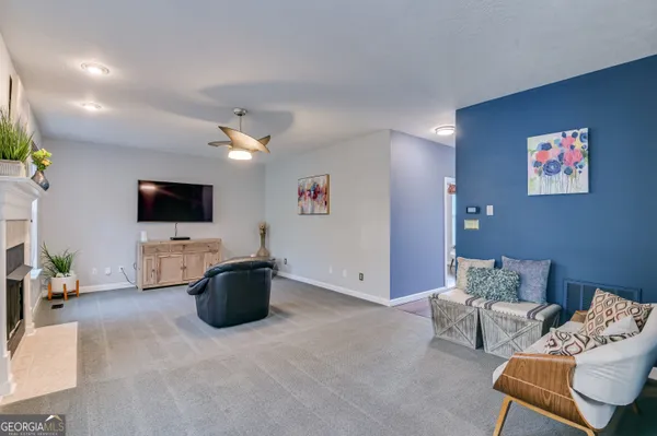 a living room with furniture and a flat screen tv